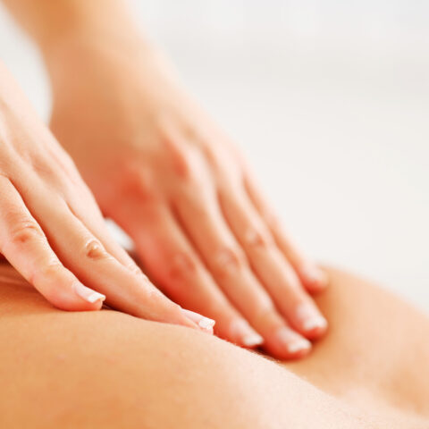 Close-up of a back massage.  White background.